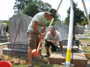 Ronald Hornsby and Dave Westbrook maintain a grave in Oakland Cemetery.  Credit: David Pendered