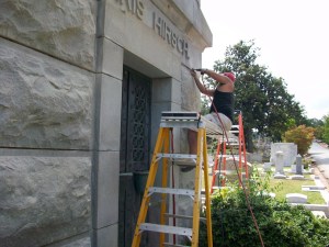 Rusty Joiner removes mortar from the Morris-Hirsch Mausoleum.  Credit: David Pendered