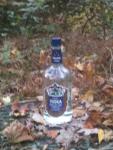 Unopened liquor bottle scrawled with writing.