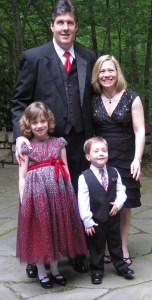Photo of the Melton family at a wedding in April: Aaron, Staci, Chloe and Charlie.