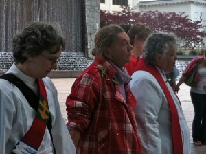 Carole Maddux, left, and Mary Wetzel, right, lead Palm Sunday service in Woodruff Park on April 1.