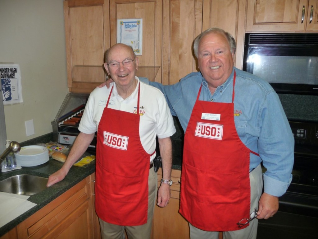 Vietnam veterans George McCoy and Dan Bennett prepare chili dogs